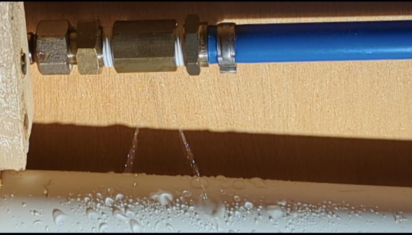 Water spraying from a pipe joint under pressure